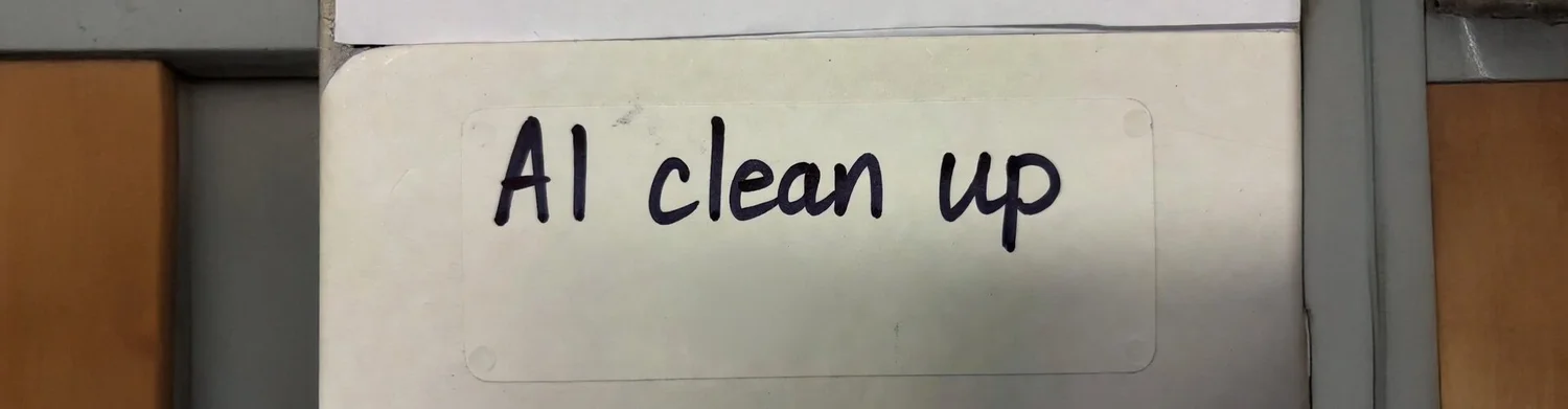 Handwritten label reading “AI clean up” on a folder, showing simple disclosure without disrupting the tone.
