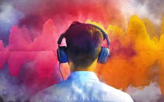A person in headphones seen from behind, surrounded by clouds of bright pink, orange and blue colour.